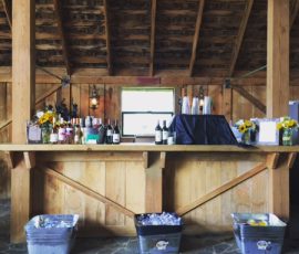 A bar with bottles of alcohol and buckets.