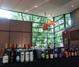 A table with bottles of alcohol and buckets.