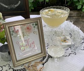 A table with a picture frame and glasses.
